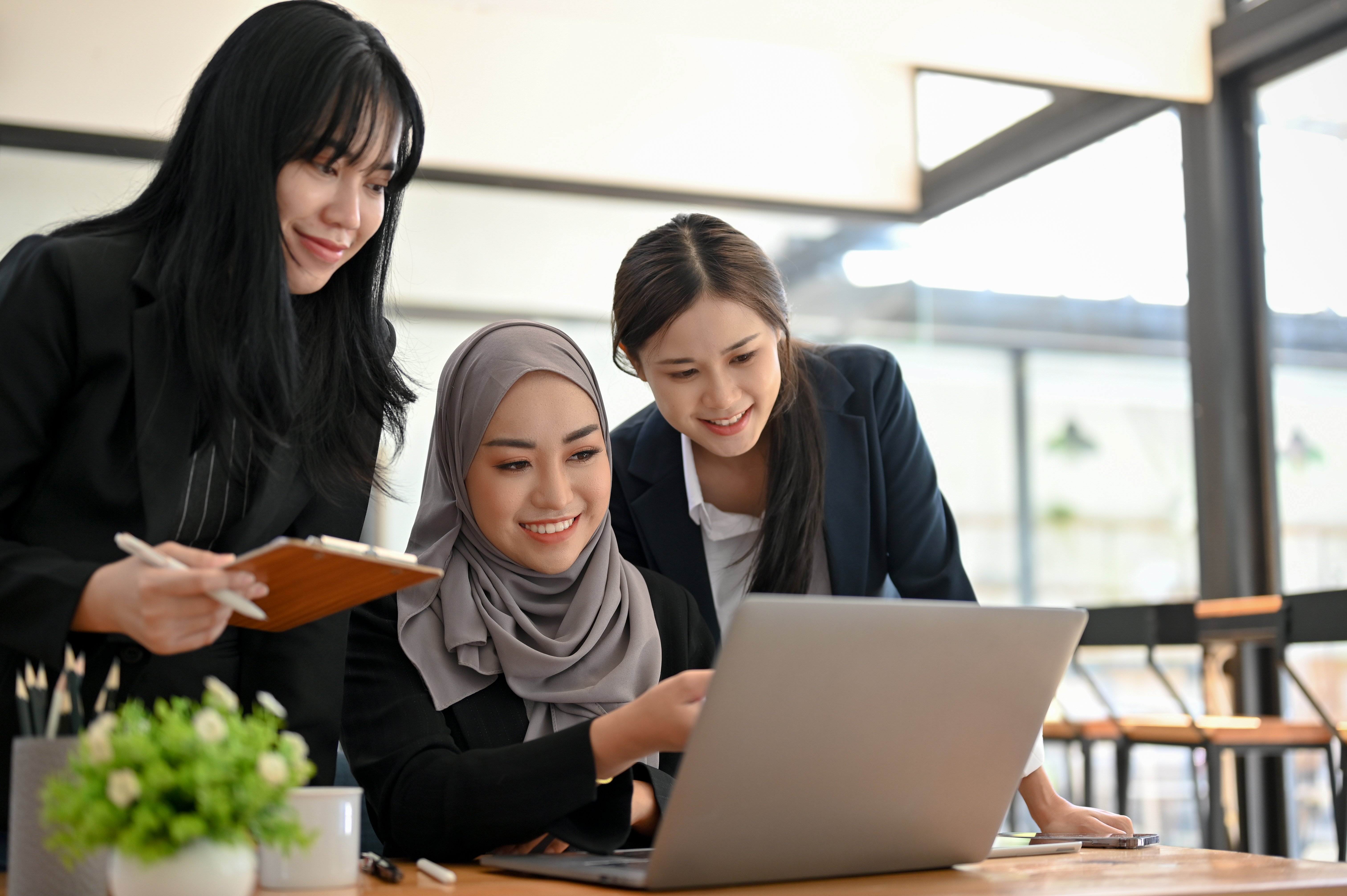 group-professional-business-financial-analysts-looking-laptop-screen-together